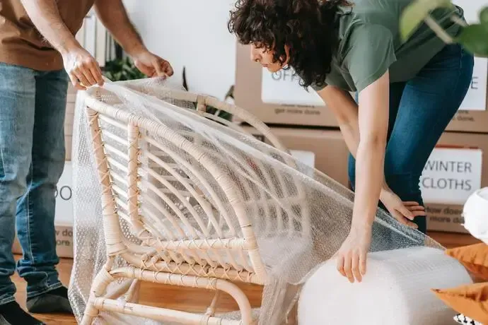 Lady wrapping and moving a chair