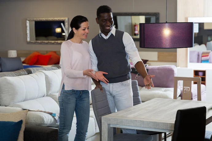 Customers standing near their new dining table furniture